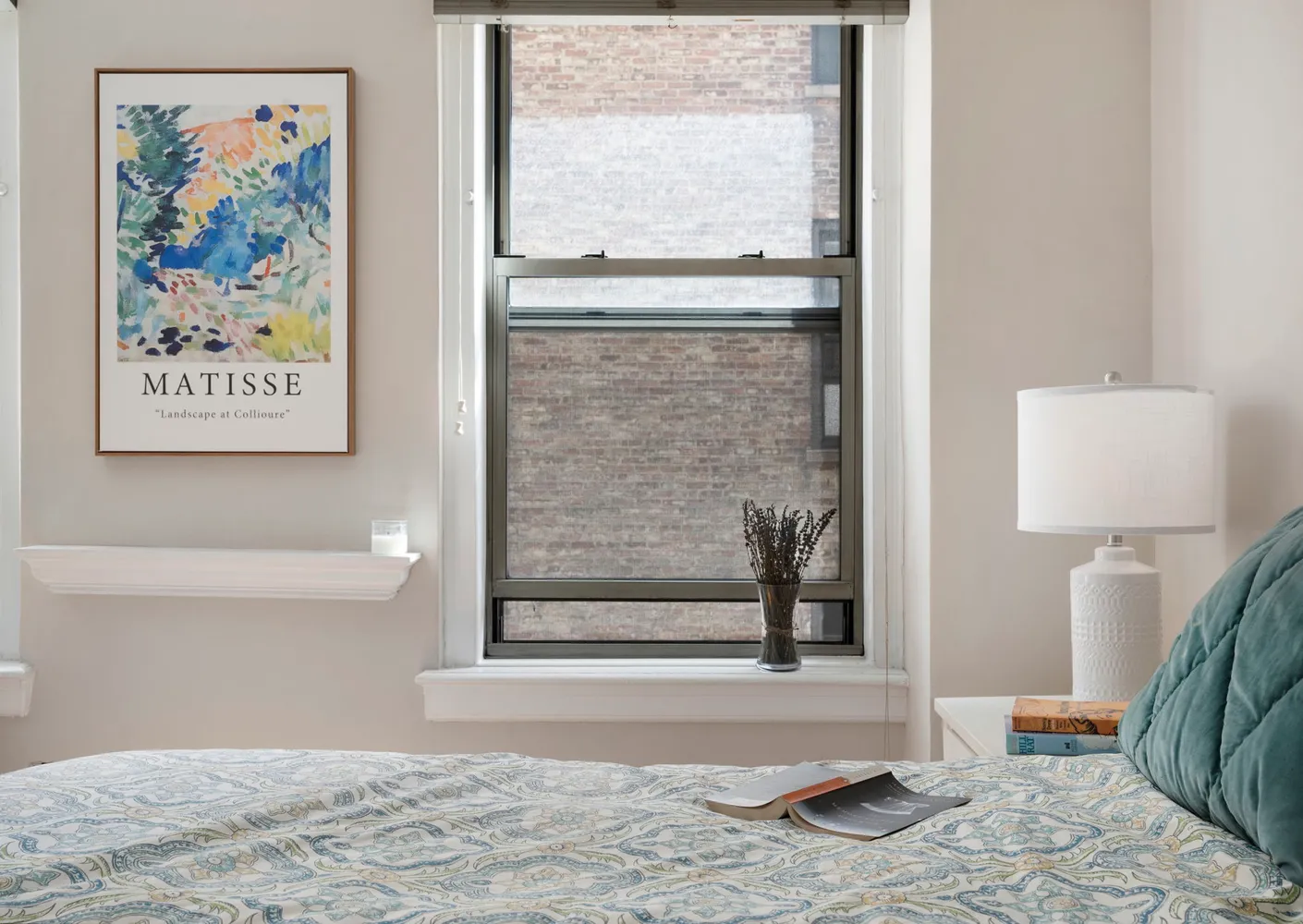 a view of a bedroom with wooden floor and a window