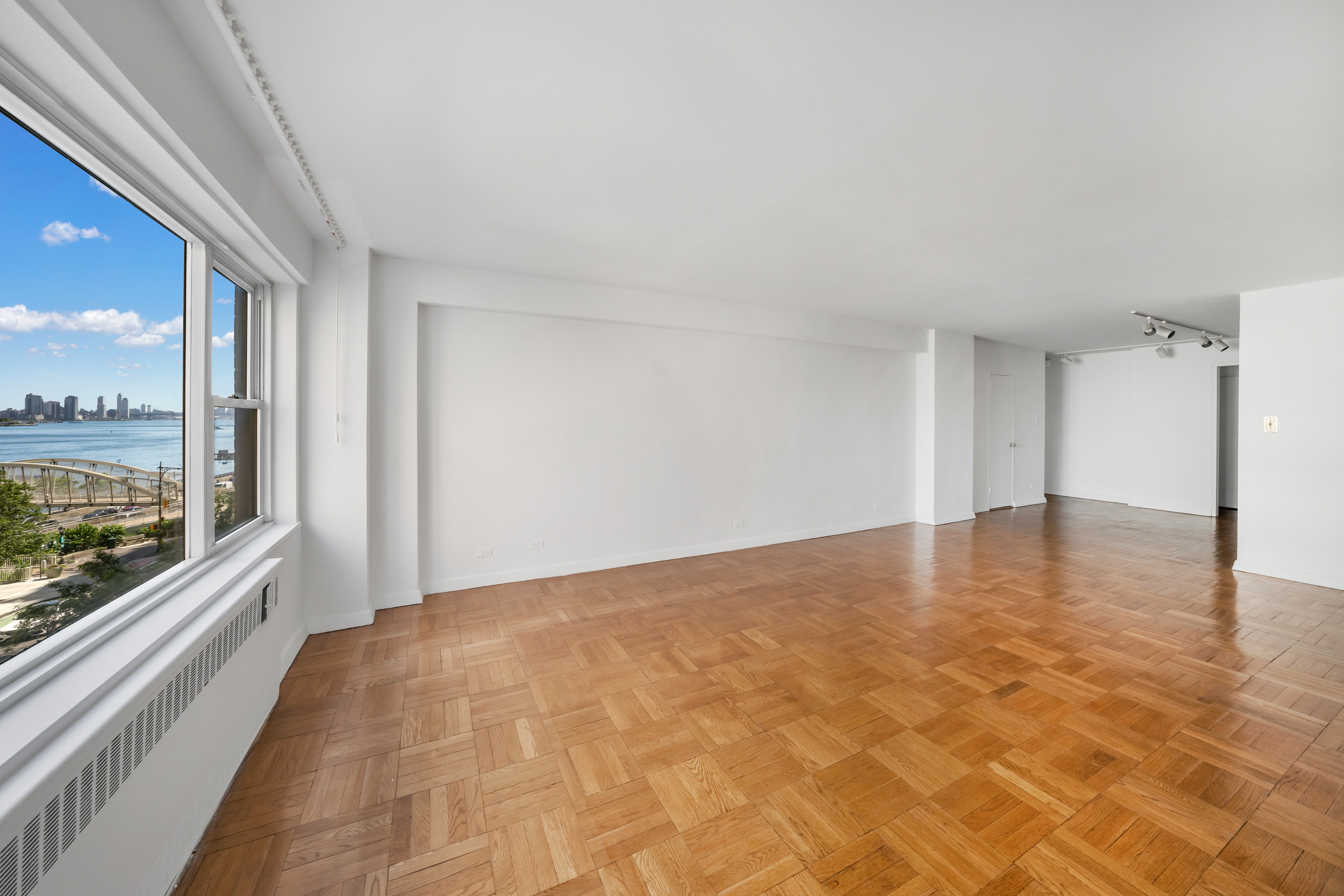 50 Sutton Place South, Unit 5E Manhattan, NY 10022 - Photo 2 of 13 a view of an empty room and window