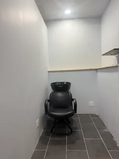 a room with a chair and a potted plant