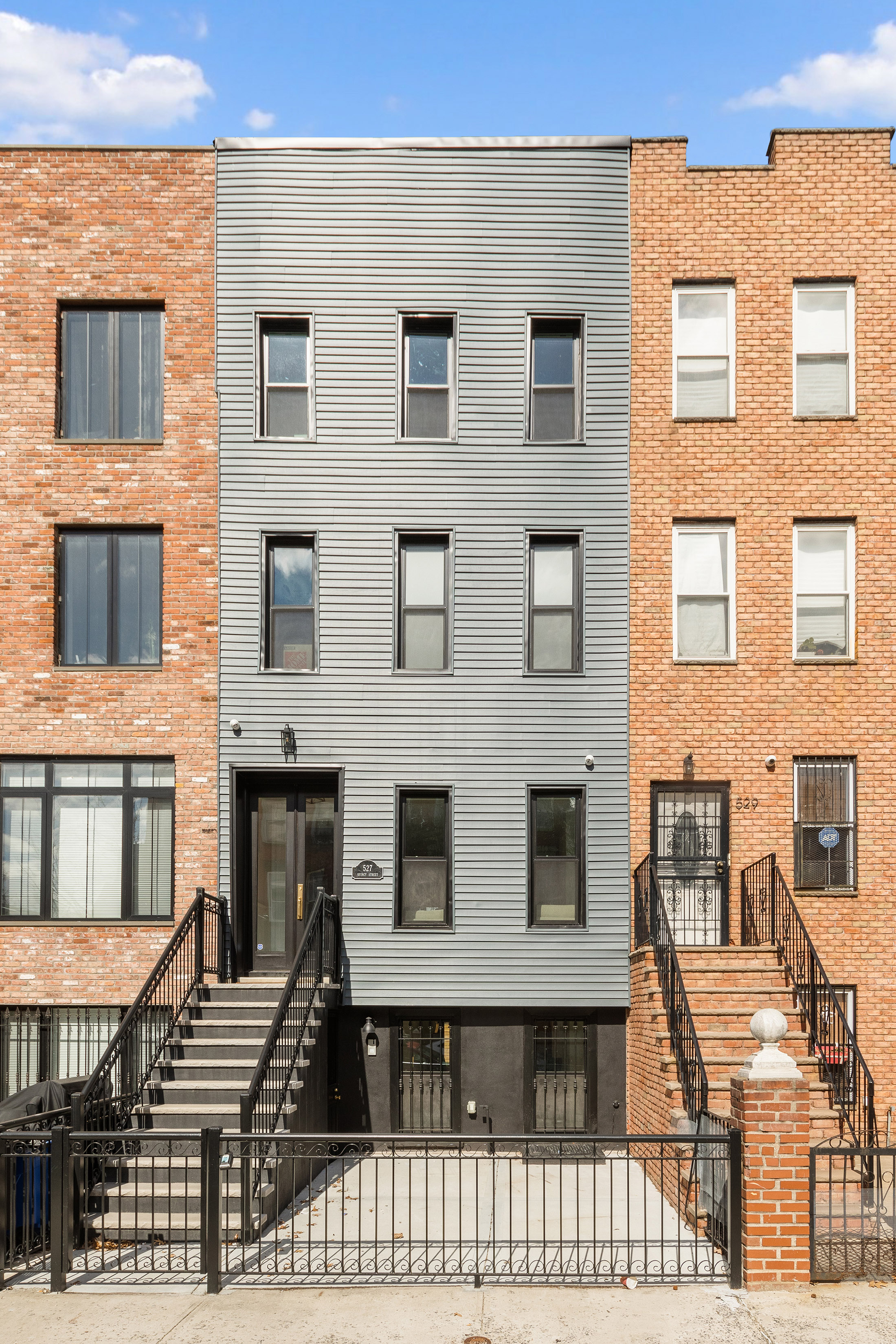 527 Quincy Street, Unit 1 Brooklyn, NY 11221 - Photo 7 of 8 a front view of a house with many windows