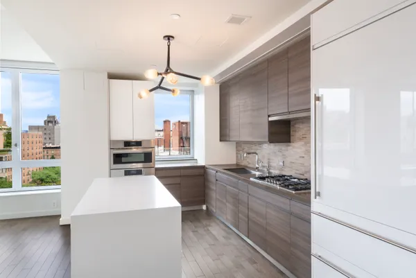 a kitchen with a stove a sink and a refrigerator