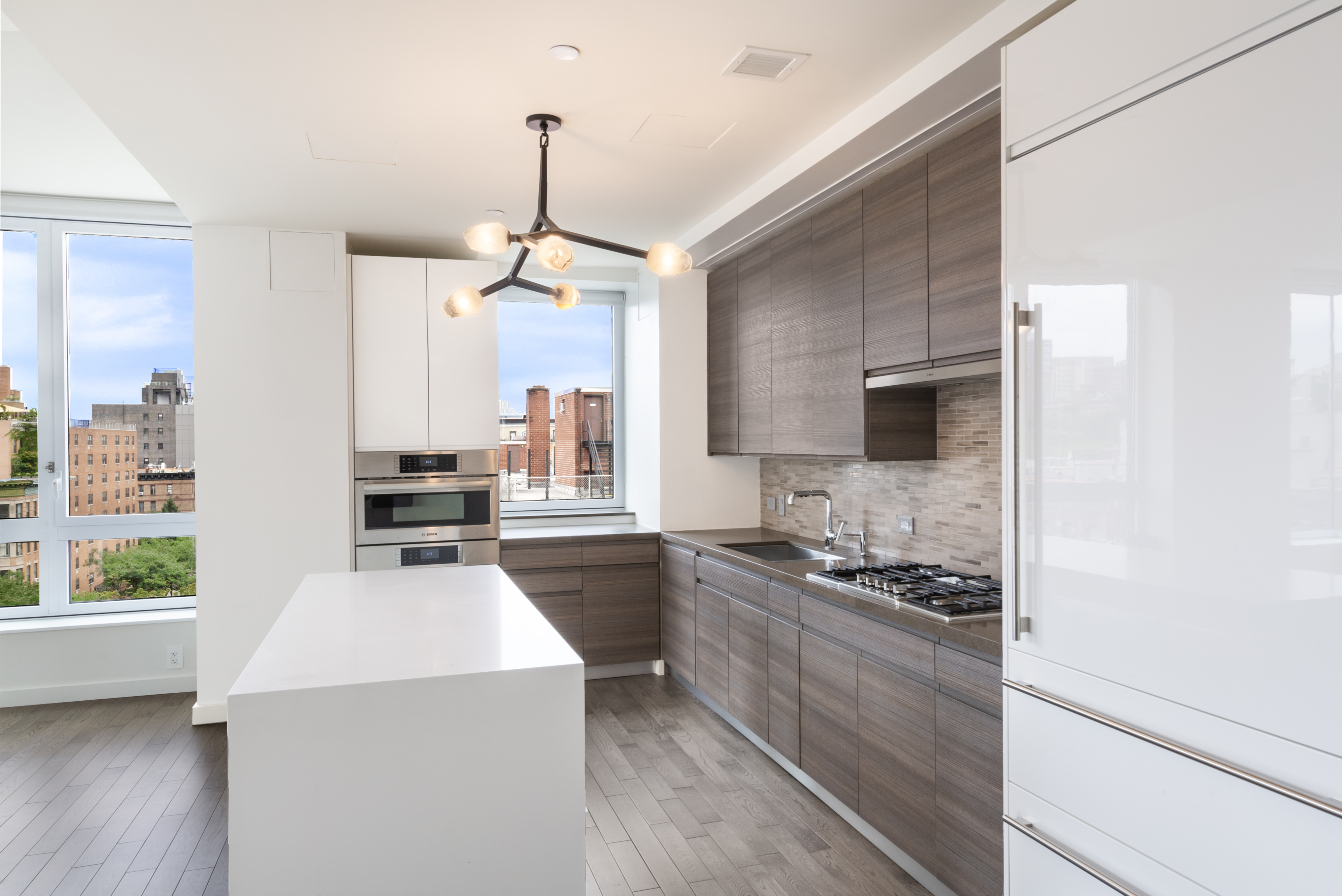285 West 110th Street, Unit 7B Manhattan, NY 10026 - Photo 3 of 10 a kitchen with a stove a sink and a refrigerator