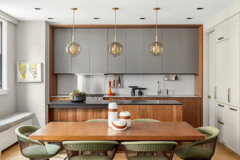 a kitchen with a table chairs and a microwave