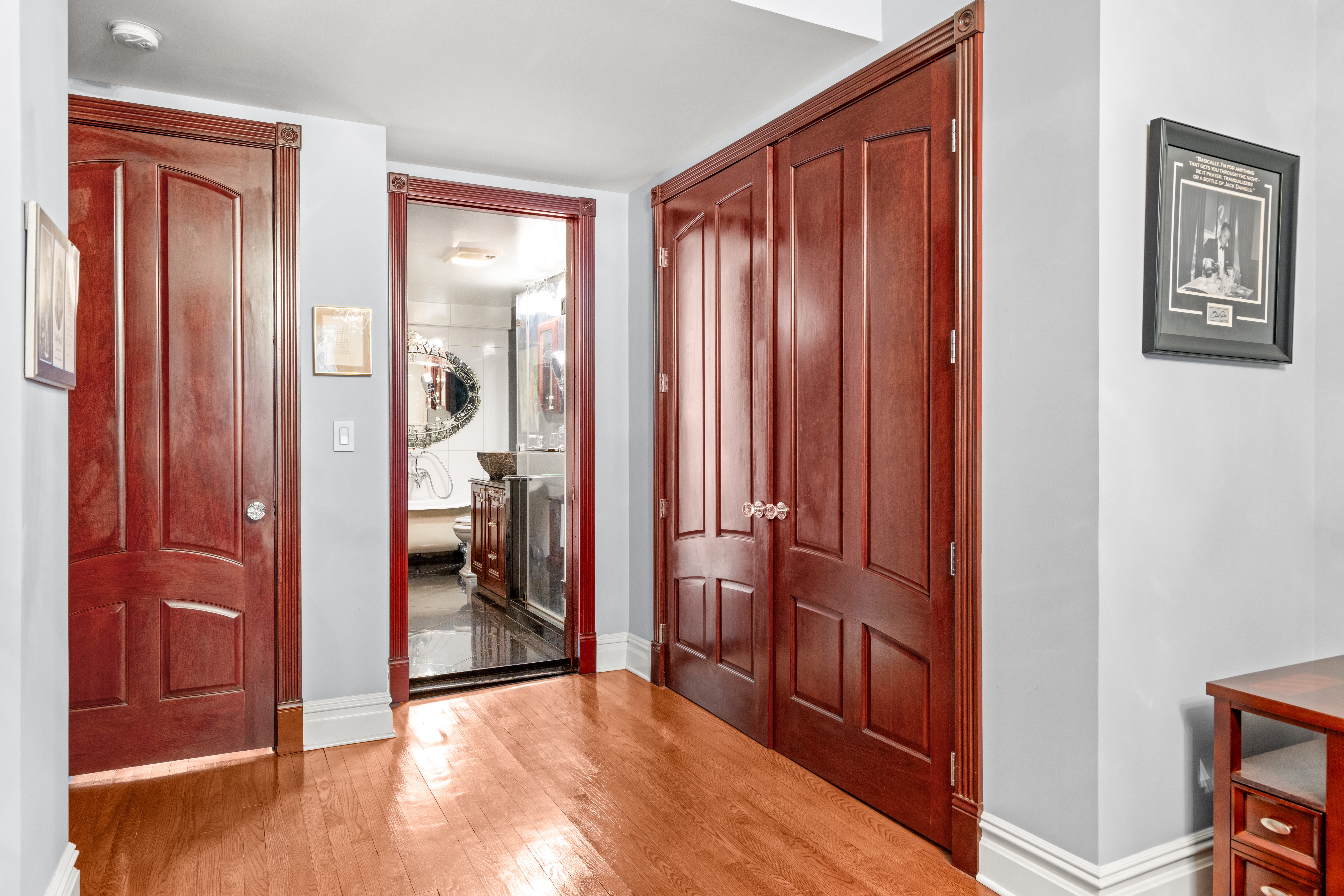 575 Park Avenue, Unit 108 Manhattan, NY 10065 - Photo 8 of 18 a view of a hallway with bathroom and wooden floor