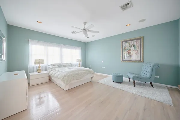 a spacious bedroom with a bed and a couch