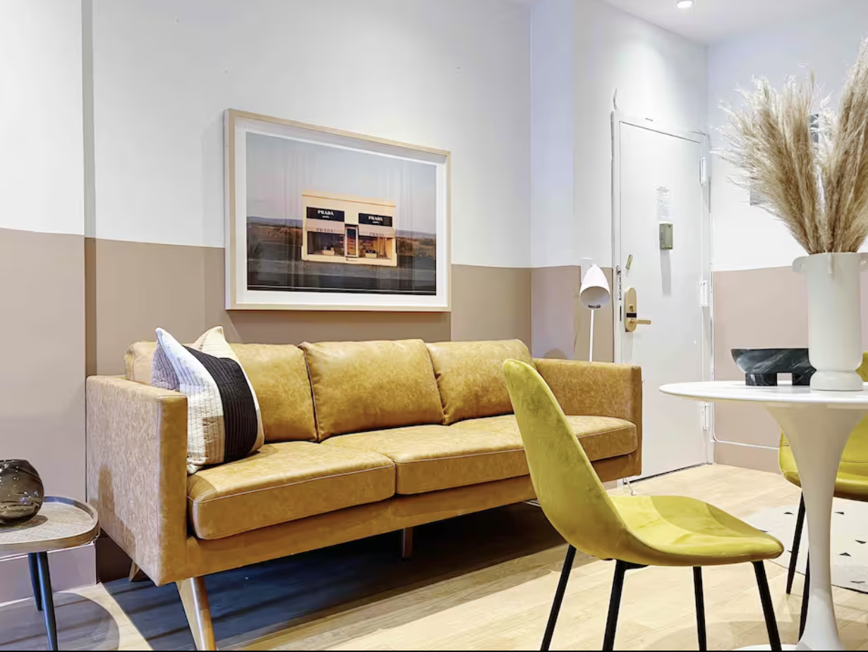 9 Spring Street, Unit 23 Manhattan, NY 10012 - Photo 2 of 7 a living room with furniture and a potted plant