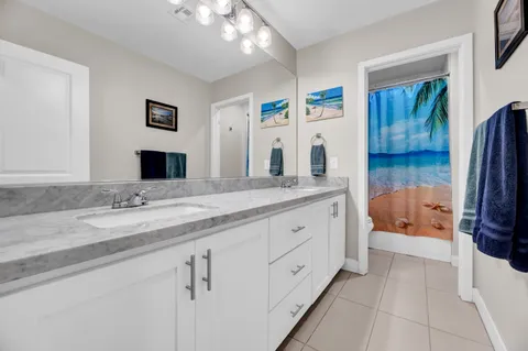 a spacious bathroom with a granite countertop sink and a mirror