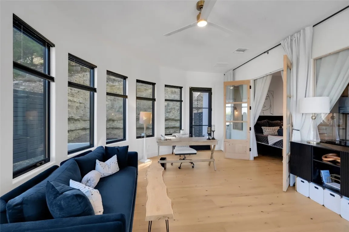 a living room with furniture large window and flat screen tv