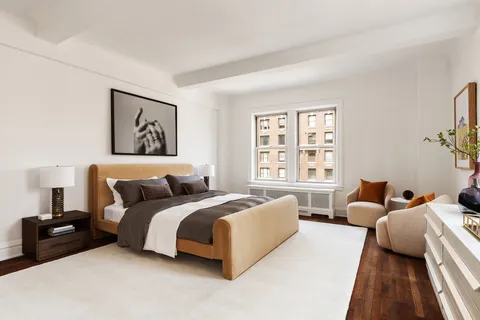 a spacious bedroom with a bed couch and a window