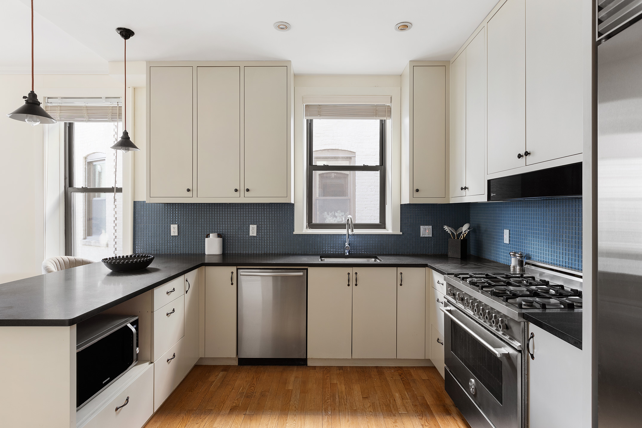 1845 Adam Clayton Powell Jr Boulevard, Unit 5C Manhattan, NY 10026 - Photo 4 of 17 a kitchen with a sink stove top oven and cabinets