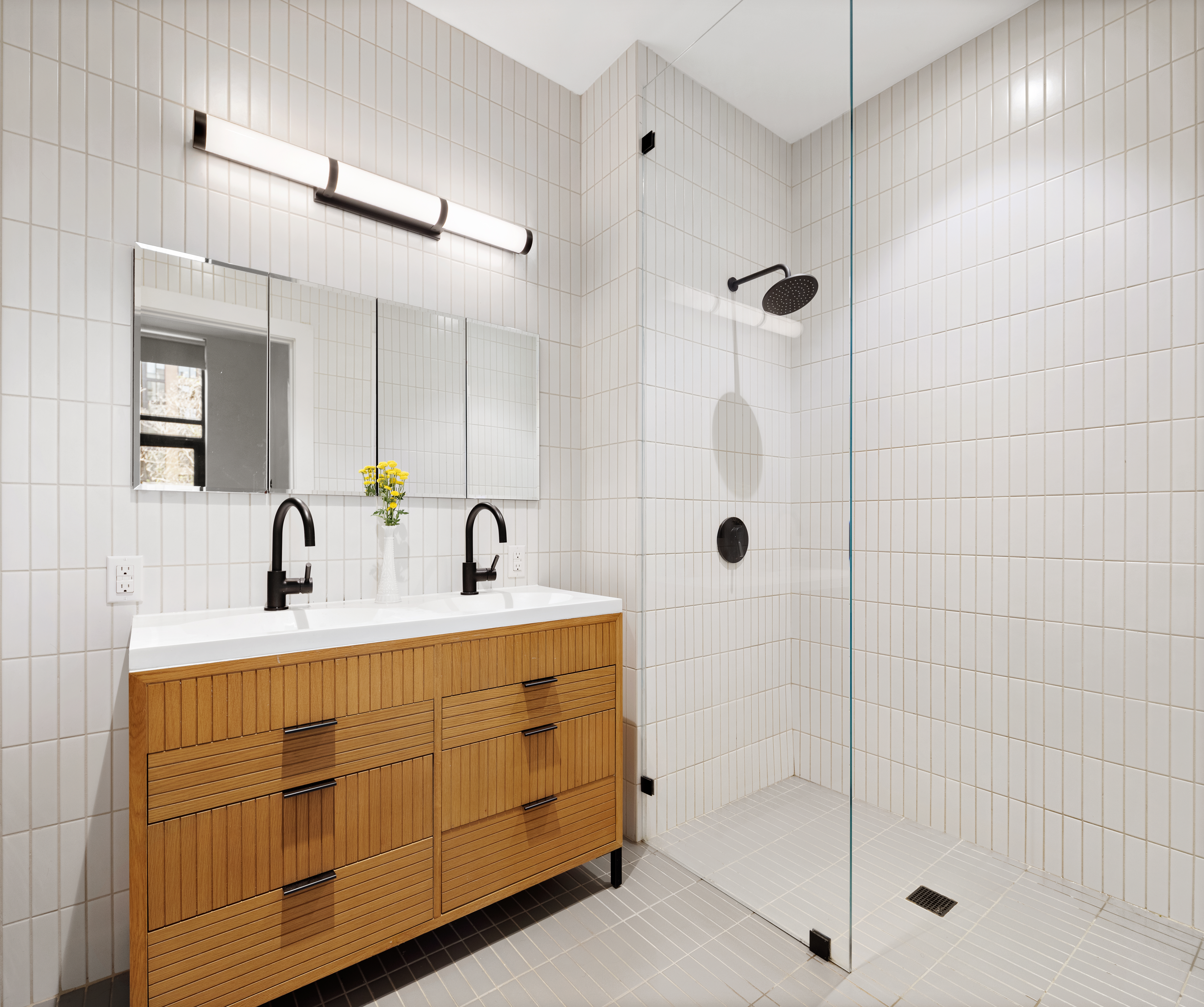 111 Montgomery Street, Unit 1C Brooklyn, NY 11225 - Photo 4 of 15 a bathroom with a shower sink and mirror