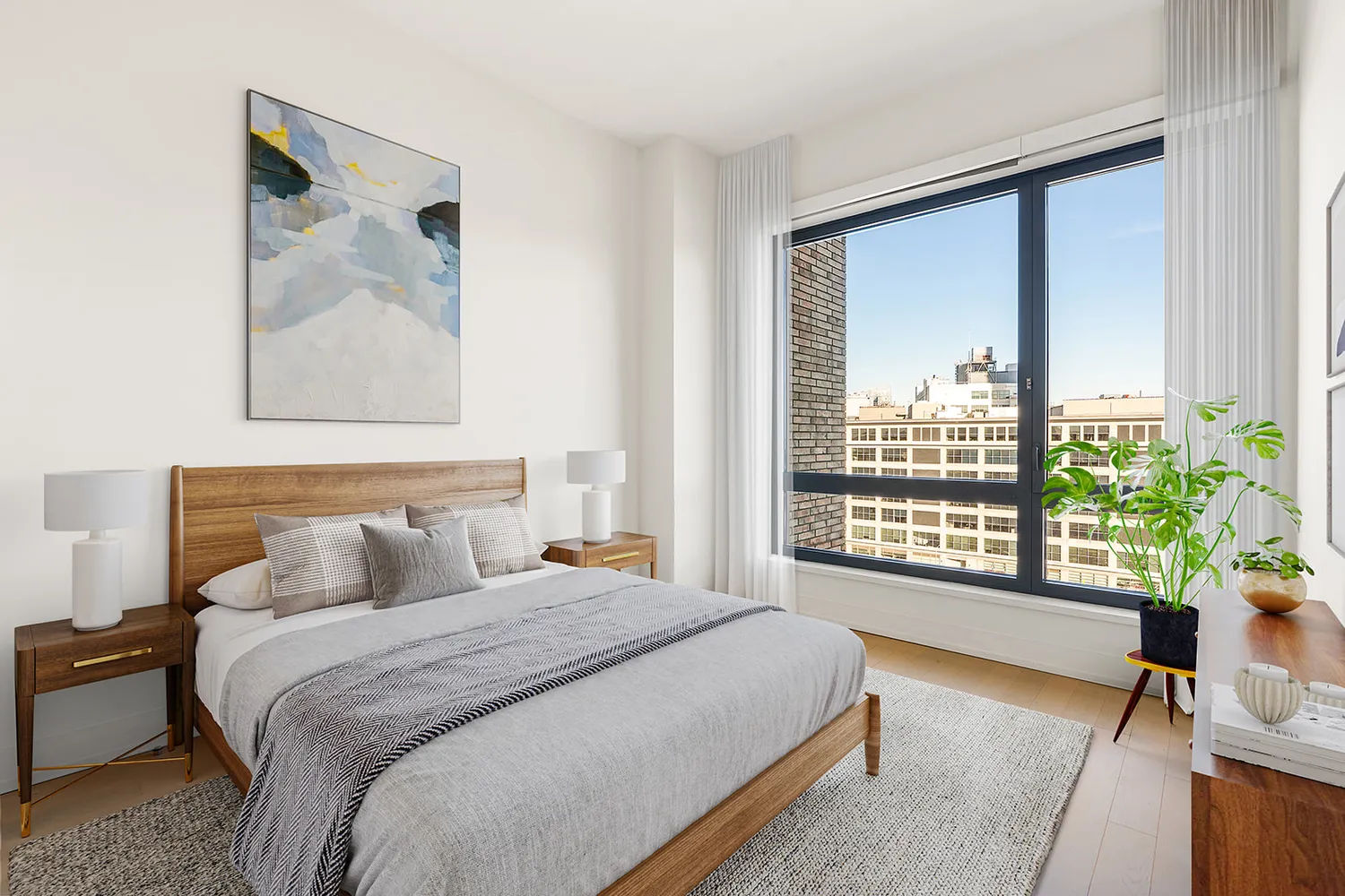 a bedroom with a large bed and a window