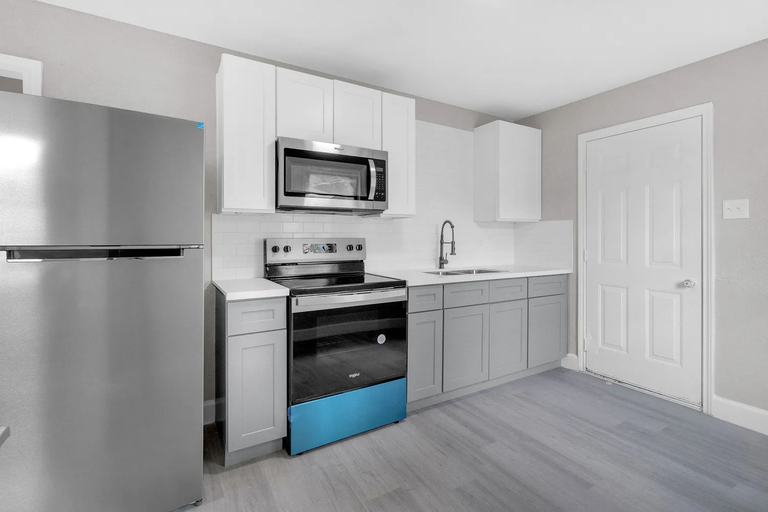 a kitchen with a refrigerator stove and microwave