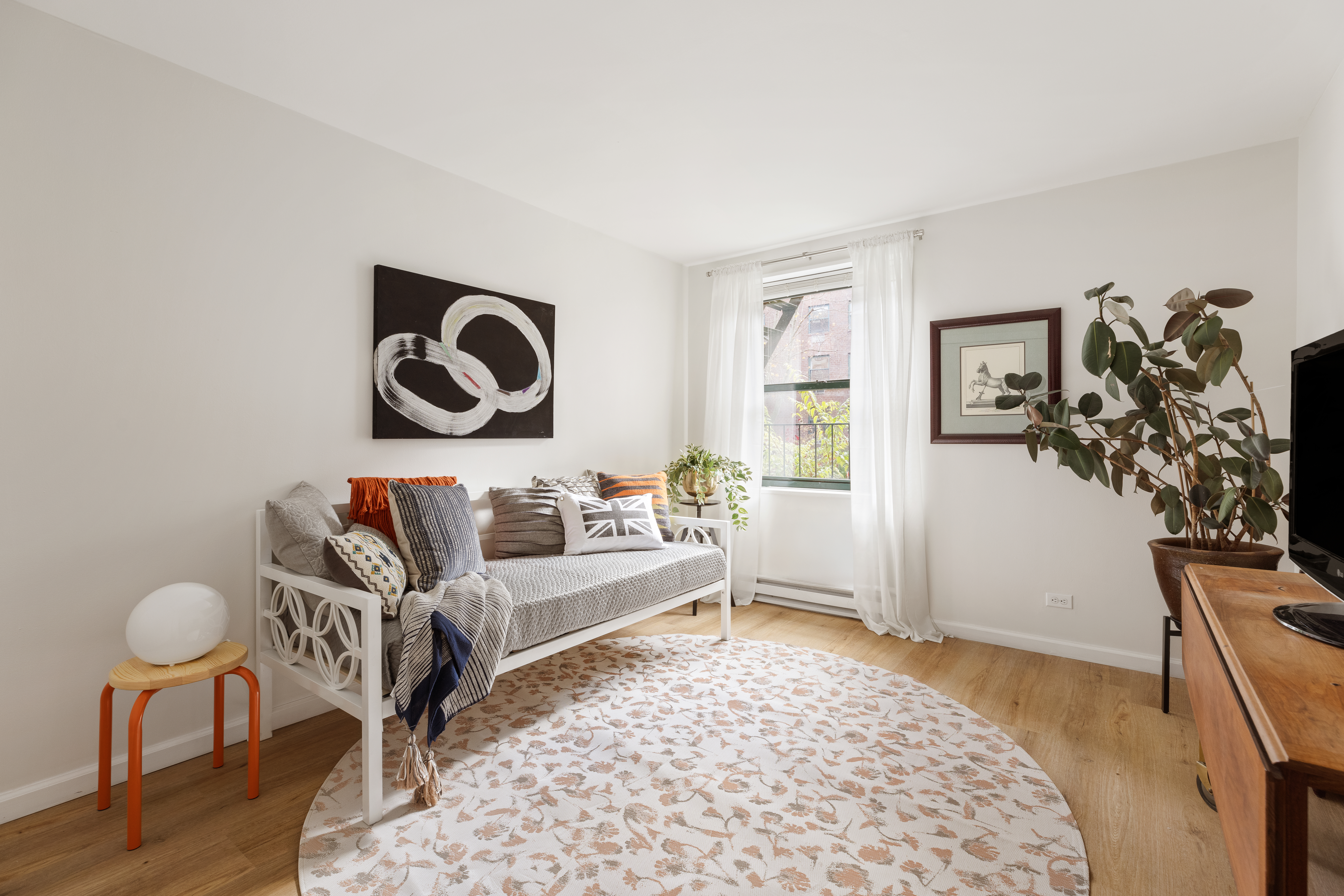 141 Barrow Street, Unit 1B Manhattan, NY 10014 - Photo 5 of 10 a bedroom with furniture and a window