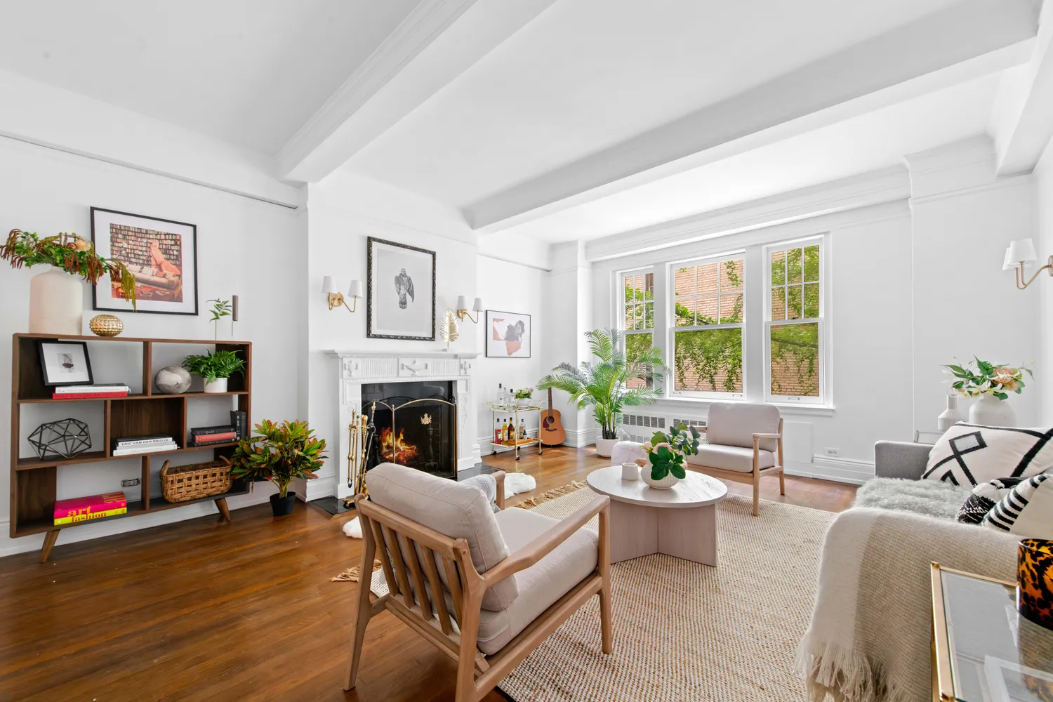 a living room with furniture a fireplace and a large window