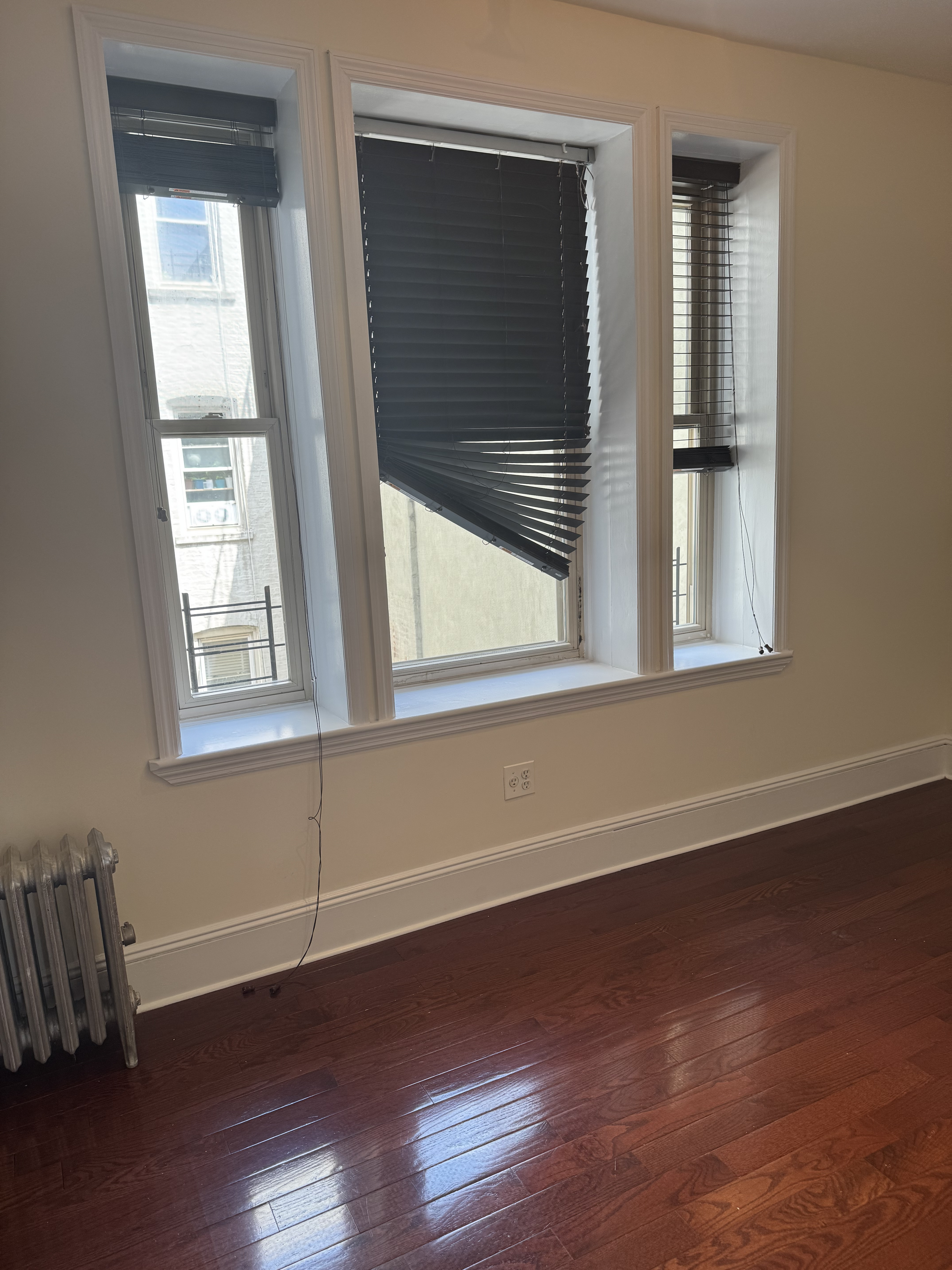 260 Cumberland Street, Unit 15 Brooklyn, NY 11205 - Photo 6 of 10 a view of an empty room with wooden floor and a window