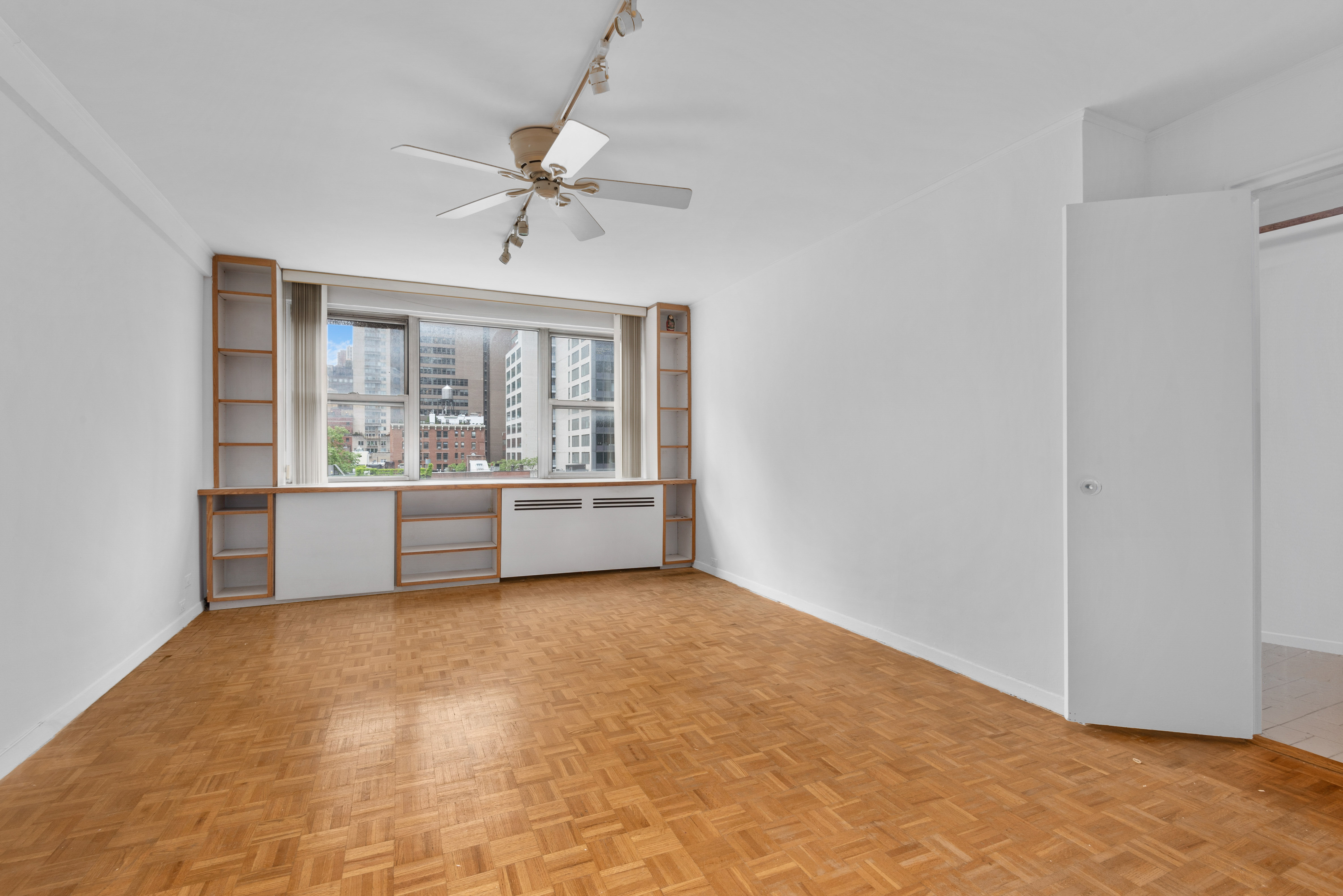 221 East 50th Street, Unit 8B Manhattan, NY 10022 - Photo 2 of 9 a view of an empty room with a window