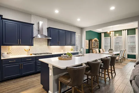 a kitchen with a dining table chairs and white appliances