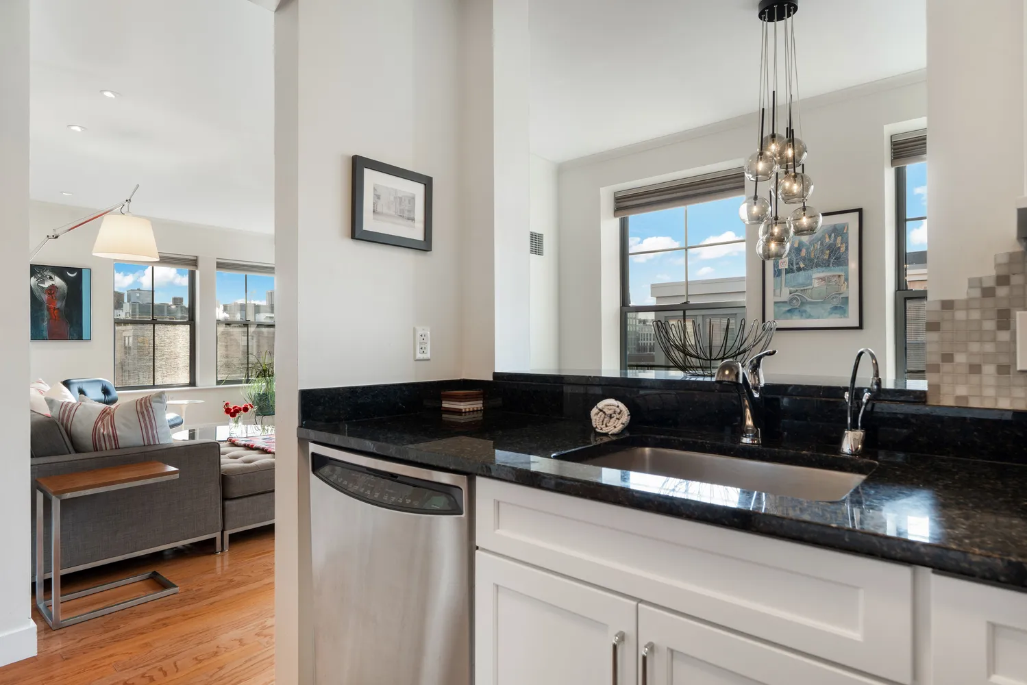a kitchen with a sink and a chandelier