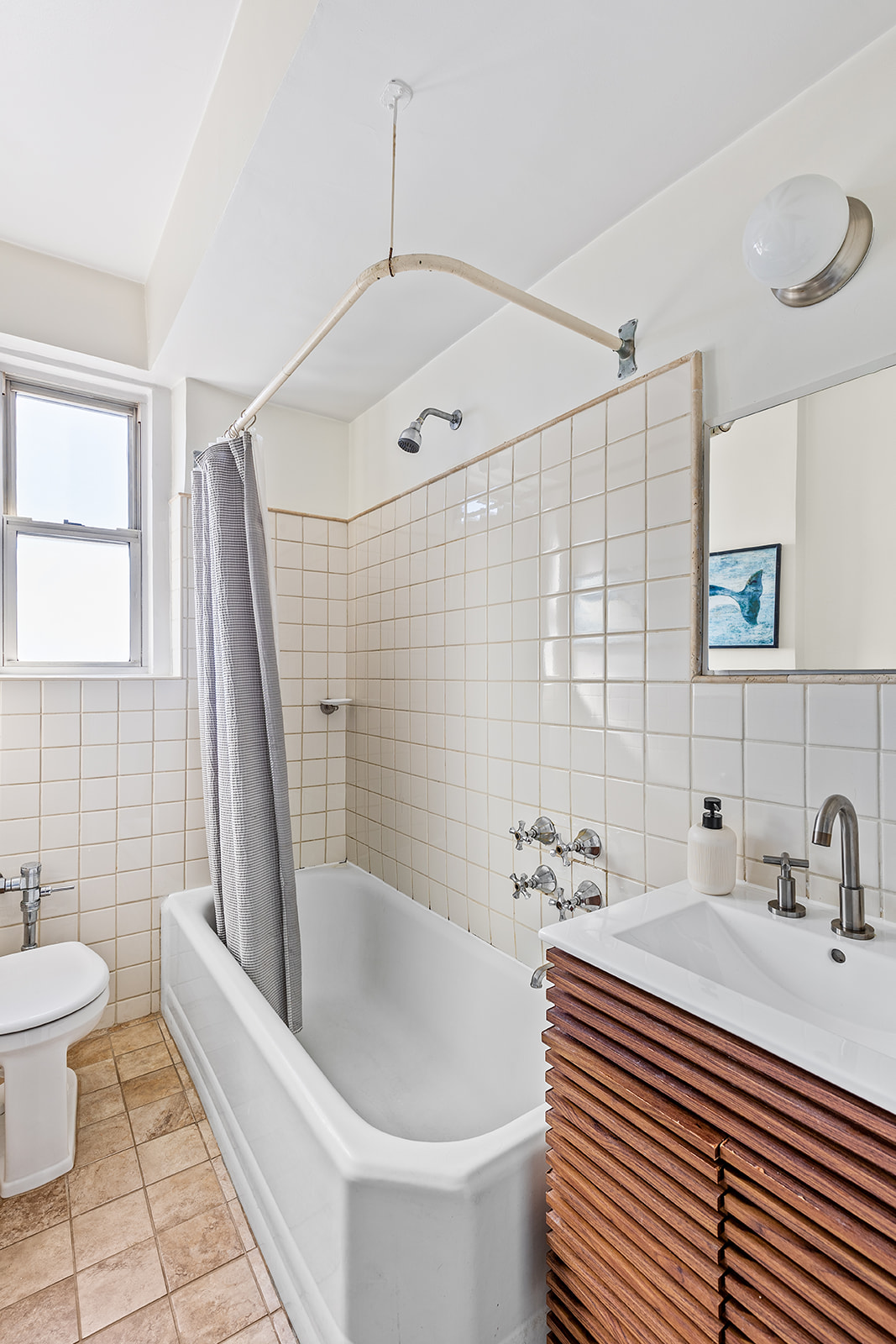 140 East 2nd Street, Unit 5B Brooklyn, NY 11218 - Photo 6 of 7 a bathroom with a sink a toilet a tub and shower