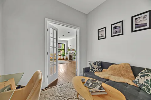 a bedroom with furniture and a wooden floor