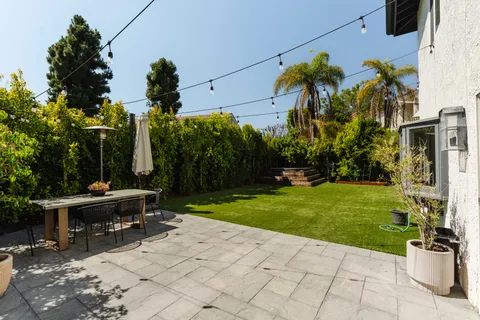 a view of a backyard with sitting area