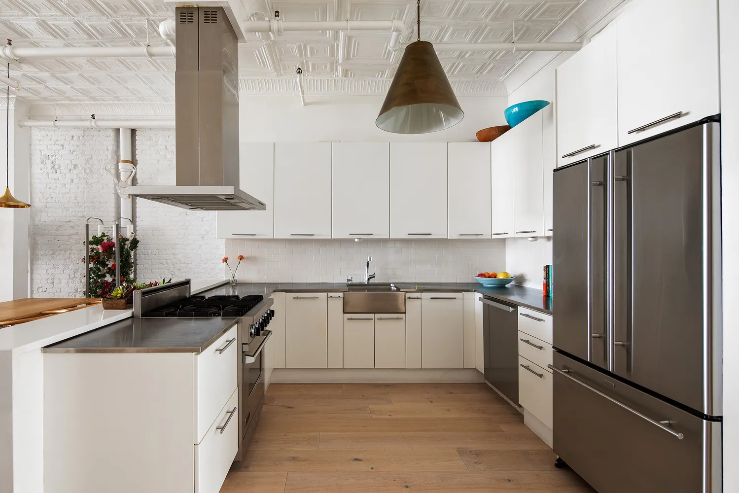 a kitchen with stainless steel appliances a sink a stove and refrigerator
