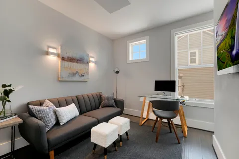 a view of a livingroom with furniture and a flat screen tv