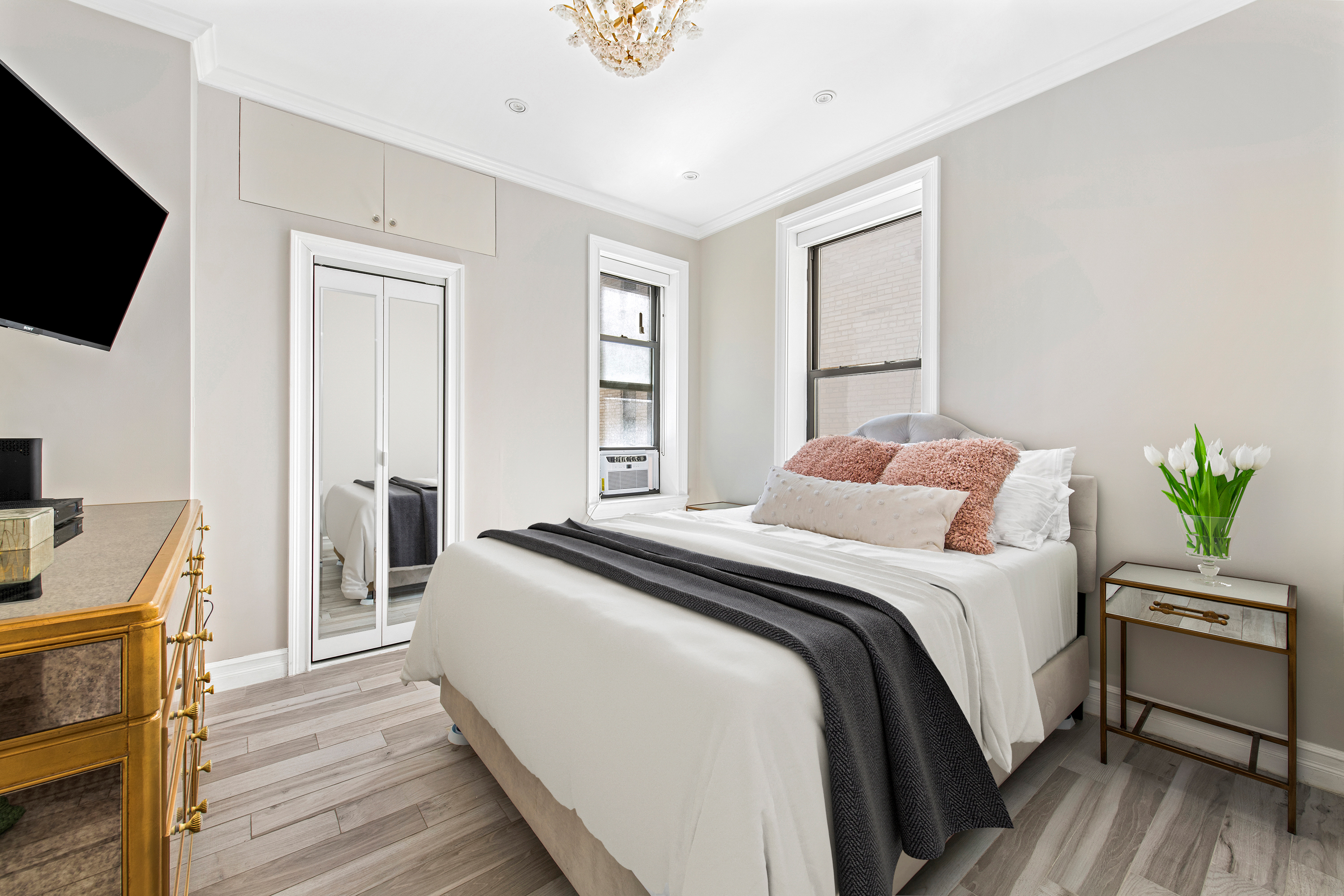 135 Ridge Street, Unit 5A Manhattan, NY 10002 - Photo 6 of 11 a bedroom with a bed and a flat screen tv