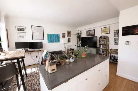 a living room with furniture a flat screen tv and a table