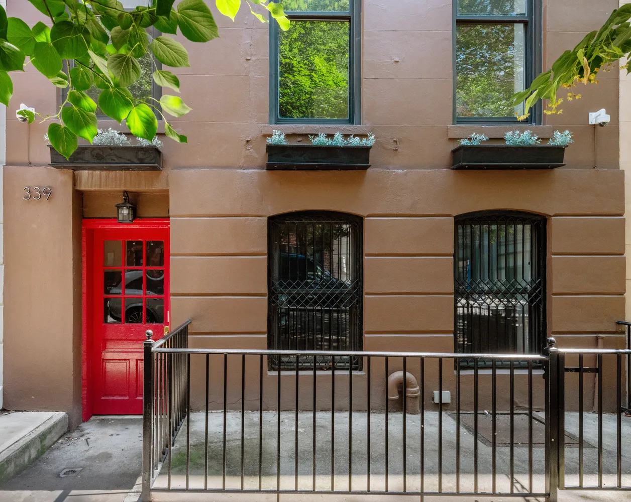 a view of a brick house with a small yard