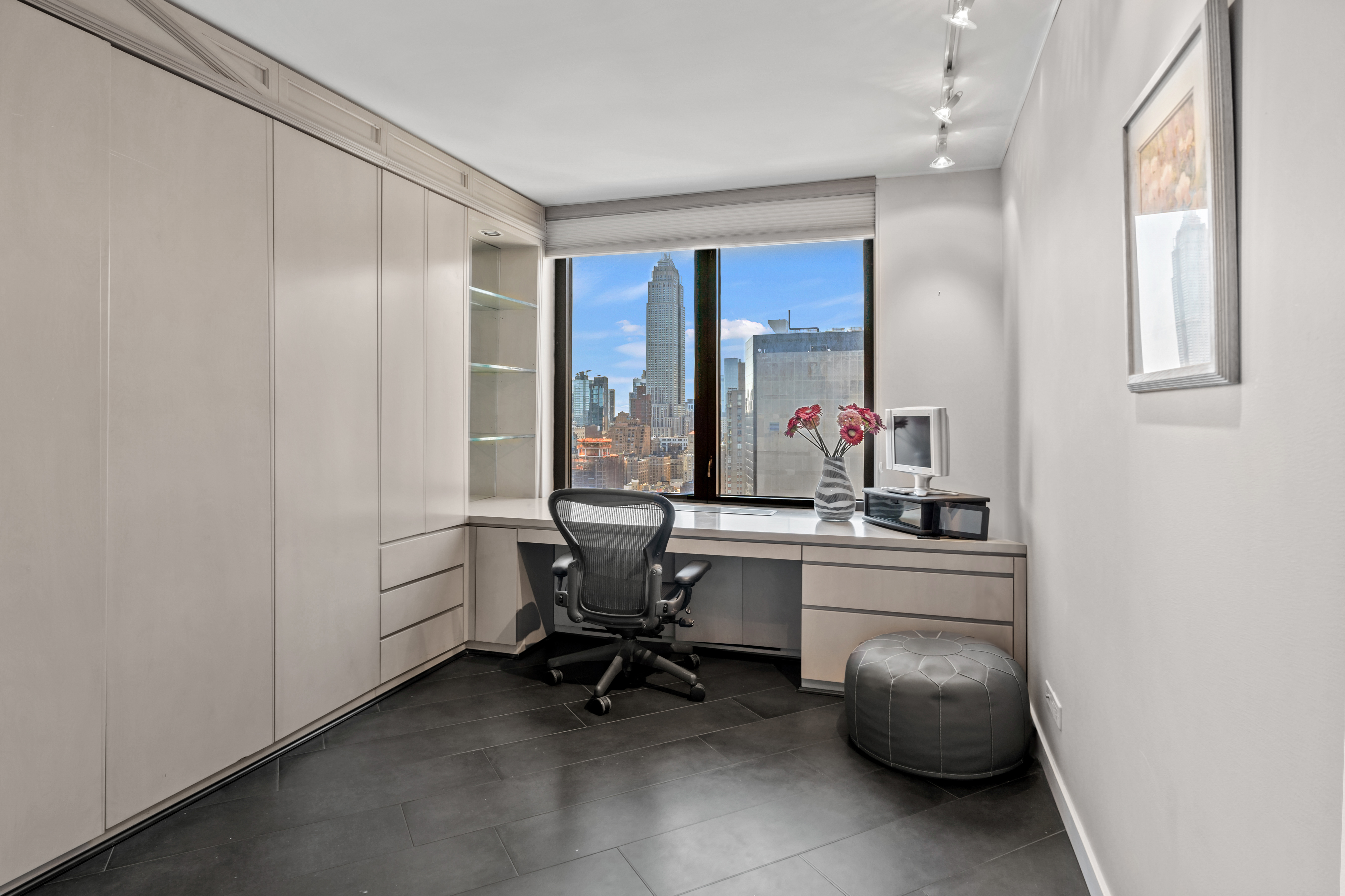 330 East 38th Street, Unit 38E Manhattan, NY 10016 - Photo 14 of 35 a view of a workspace with furniture and a window