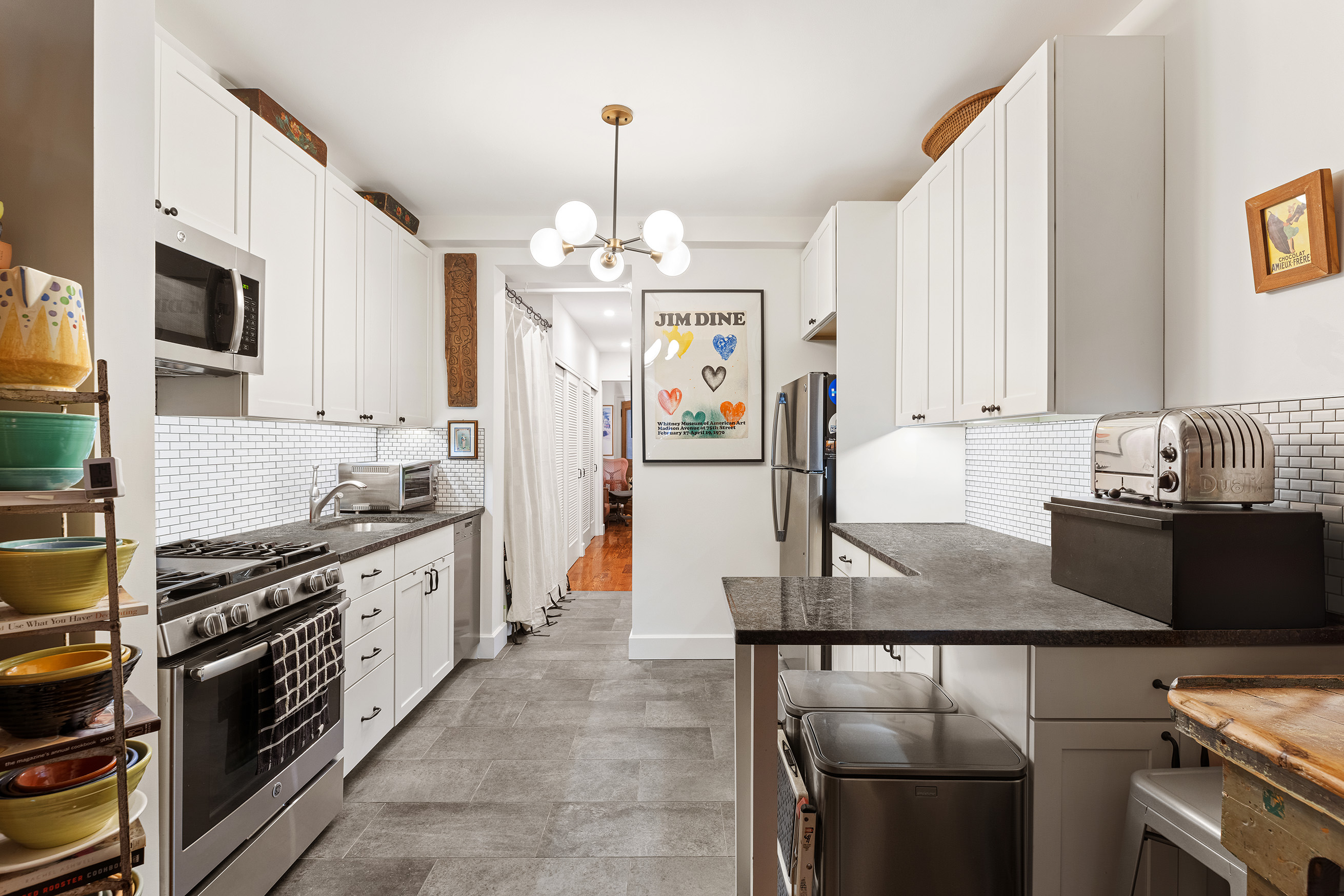 89 West 119th Street Manhattan, NY 10026 - Photo 18 of 22 a kitchen with stainless steel appliances granite countertop a sink stove and refrigerator