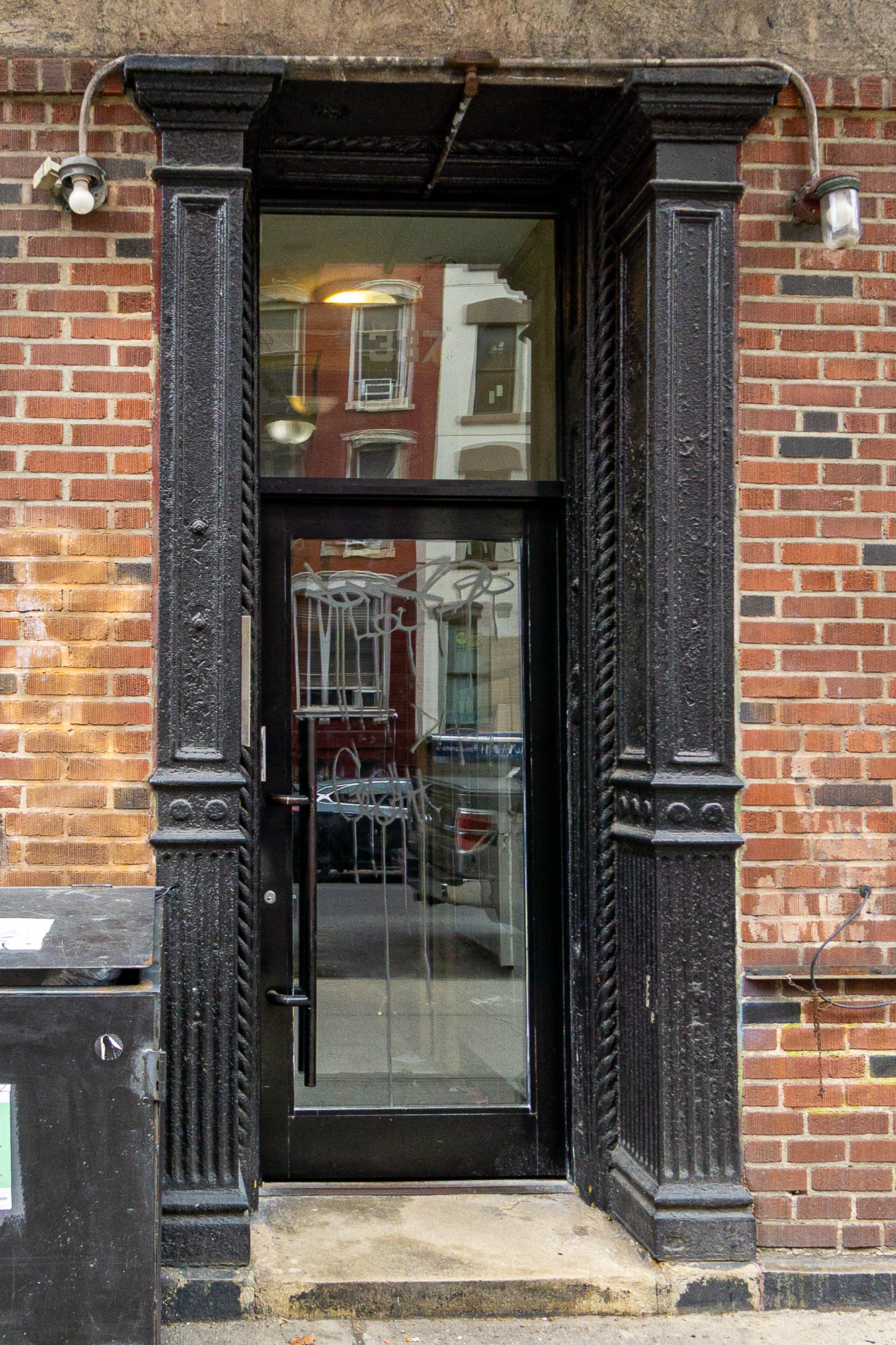 337 East 6th Street, Unit 9 Manhattan, NY 10003 - Photo 12 of 15 a front view of a house with a glass door