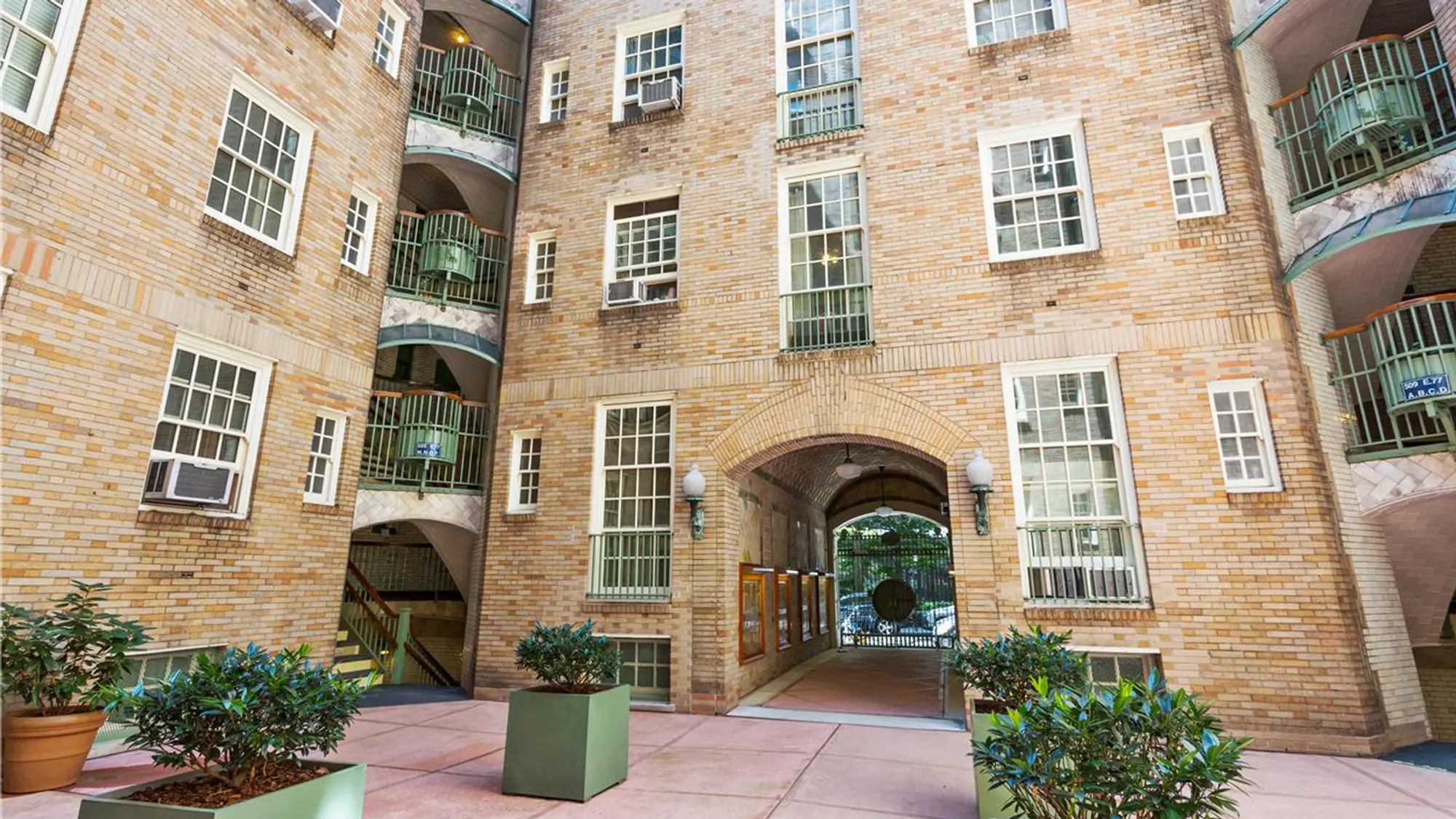 508 East 78th Street, Unit 6O Manhattan, NY 10075 - Photo 10 of 11 a front view of a building with potted plants