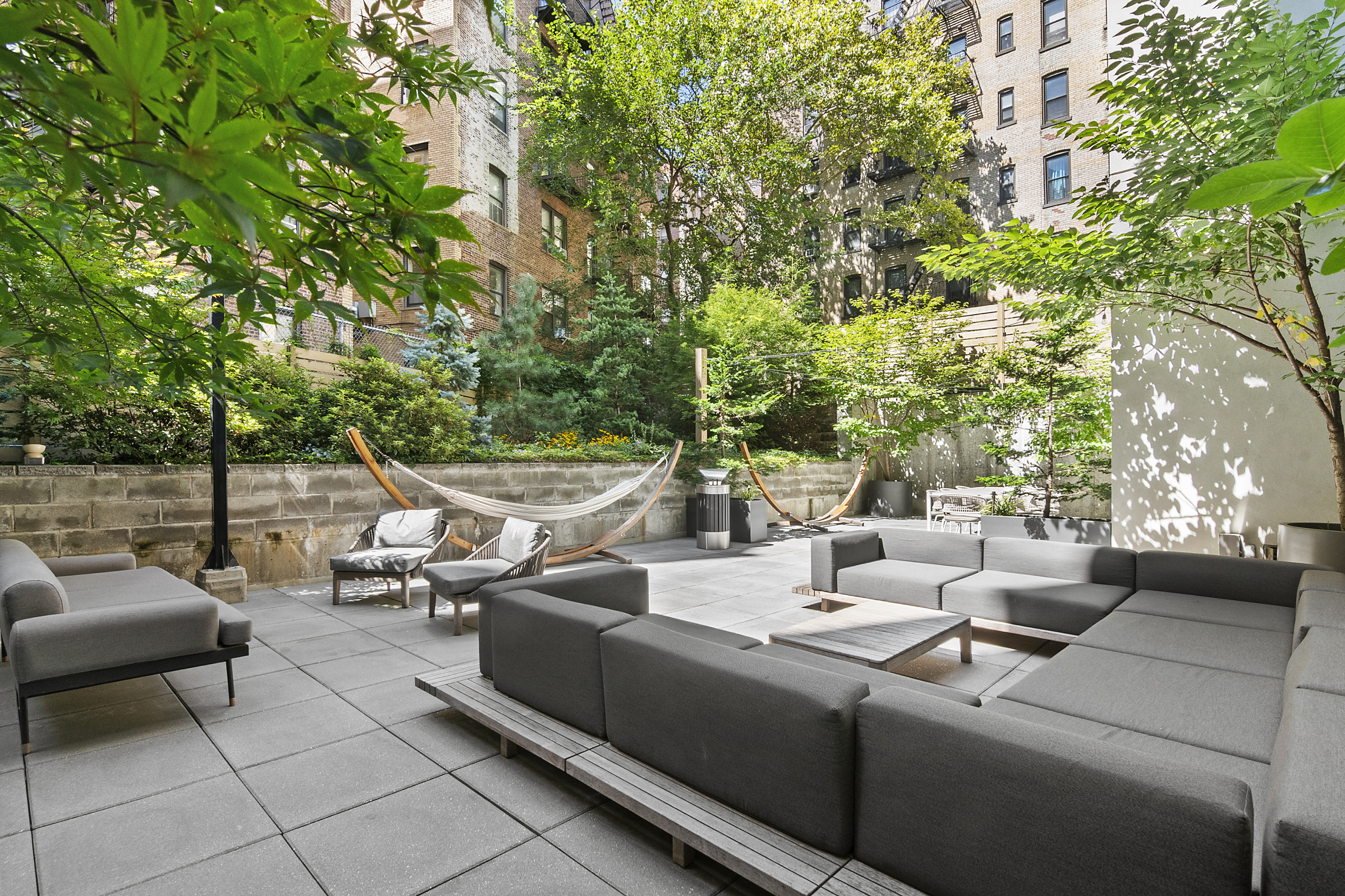 111 Montgomery Street, Unit 7CC Brooklyn, NY 11225 - Photo 12 of 18 a view of a patio with couches and chairs with potted plants and large trees