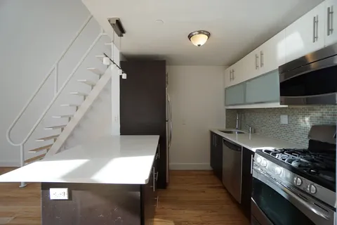 a kitchen with a stove and a refrigerator