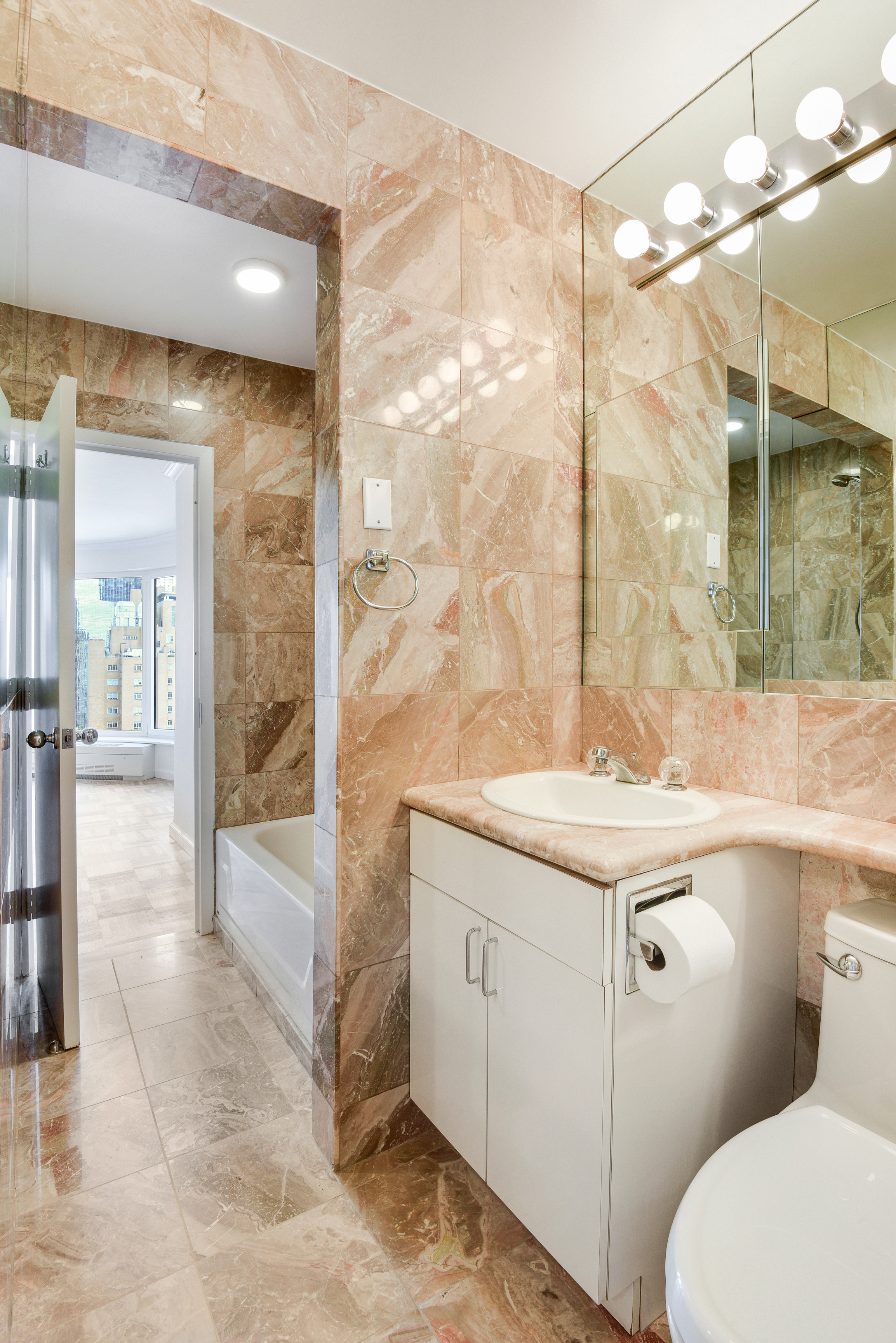 200 Central Park South, Unit 29C Manhattan, NY 10019 - Photo 19 of 23 a bathroom with a sink a toilet and shower