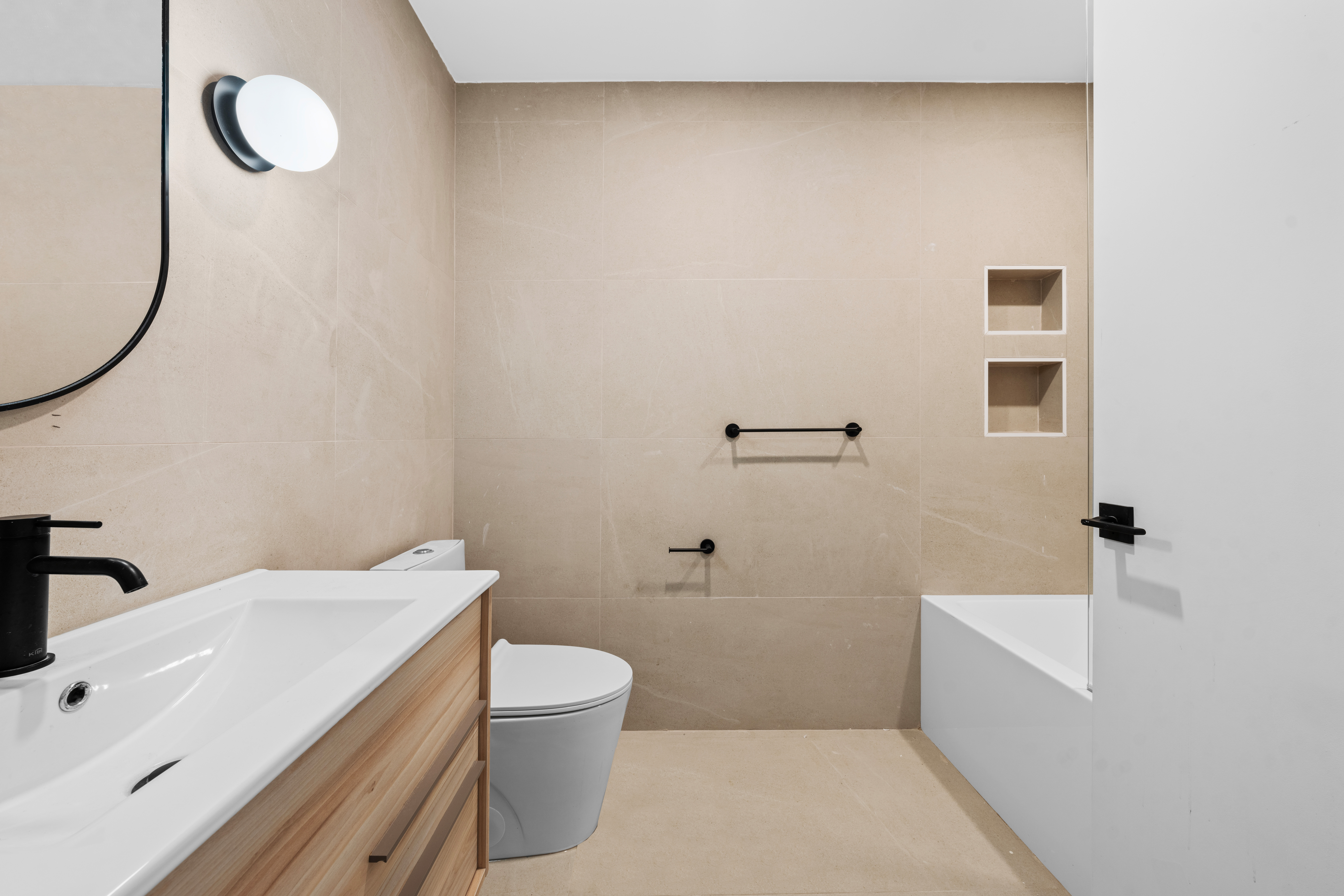 14-35 Broadway, Unit 1A Queens, NY 11106 - Photo 16 of 20 a bathroom with a sink a toilet and bathtub