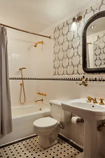 a bathroom with a toilet a sink and a shower
