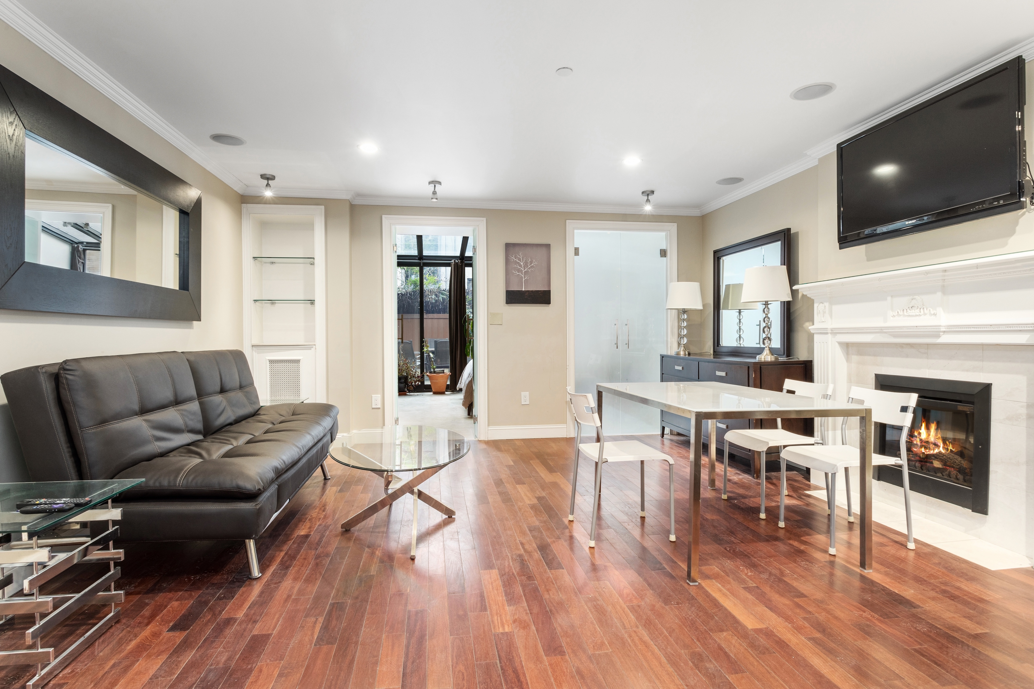 258 West 71st Street, Unit BR Manhattan, NY 10023 - Photo 9 of 13 a living room with furniture a flat screen tv and a fireplace