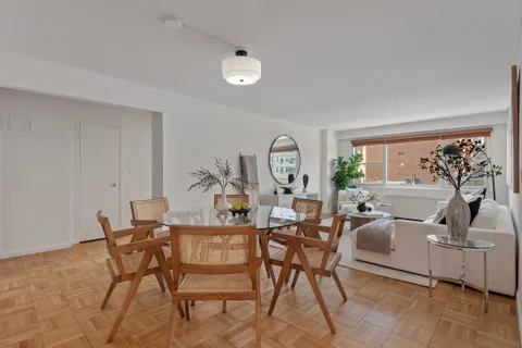 a view of a livingroom with furniture and a potted plant
