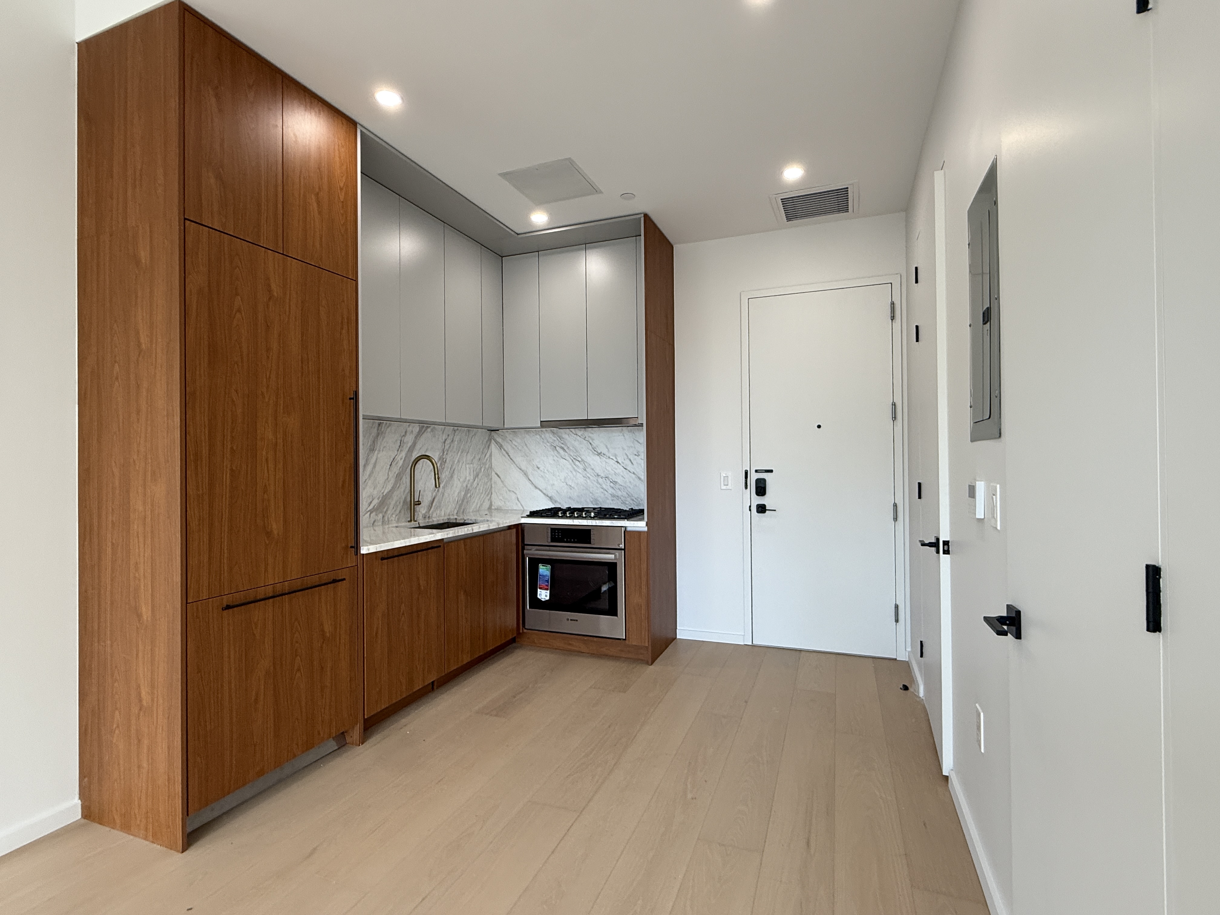 31-16 21st Street, Unit 3E Queens, NY 11106 - Photo 1 of 17 a kitchen with stainless steel appliances granite countertop a refrigerator and a sink