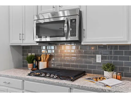 a kitchen with stainless steel appliances granite countertop a sink and a stove