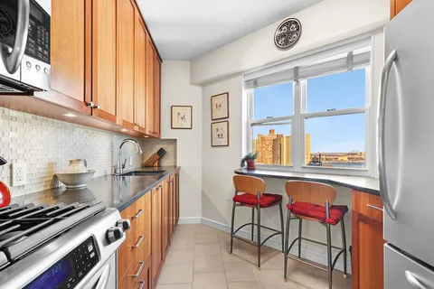 a kitchen with stainless steel appliances granite countertop a sink and cabinets