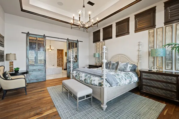 a spacious bedroom with a bed couch and a window