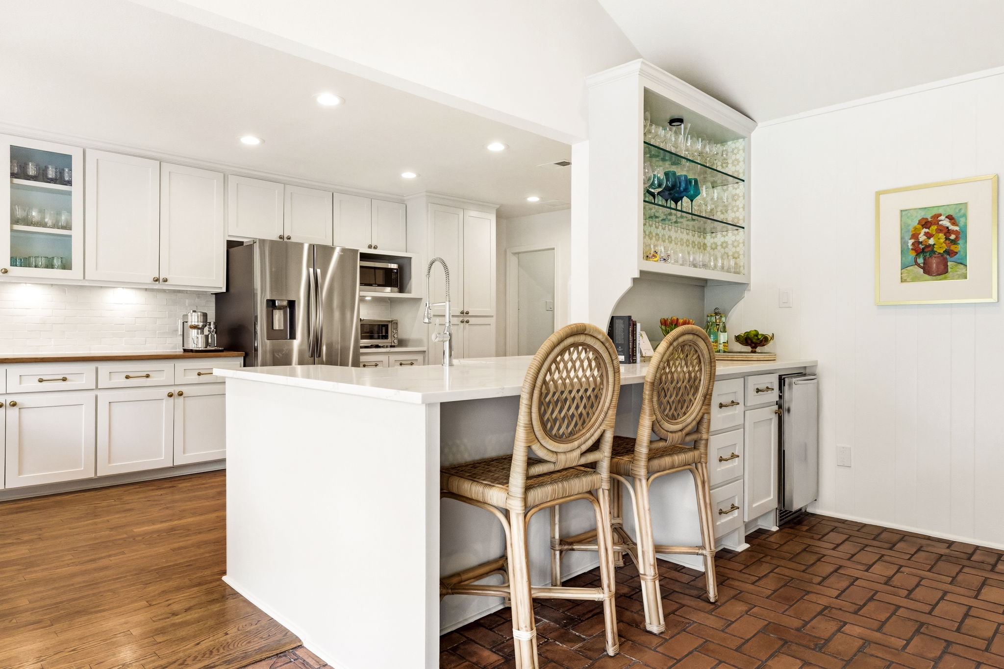 5765 Stonegate Road Dallas, TX 75209 - Photo 12 of 37 a kitchen with stainless steel appliances kitchen island granite countertop a refrigerator and microwave