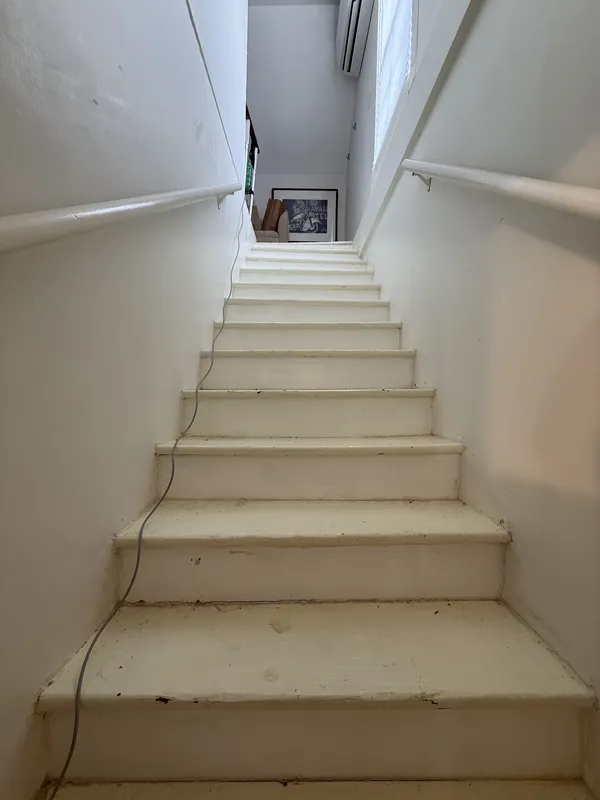 a living room with furniture and a mirror
