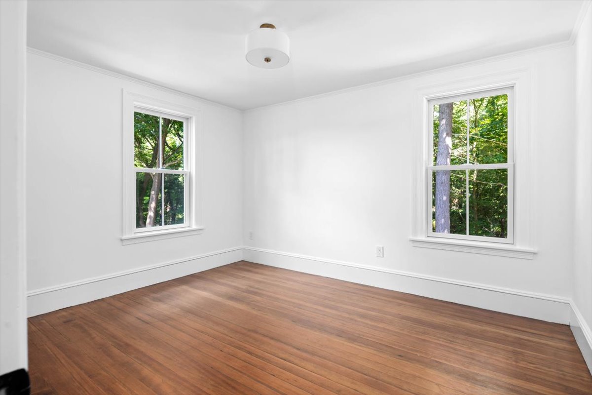 49 Garrison Road Hingham, MA 02043 - Photo 14 of 30 a view of an empty room with wooden floor and a window