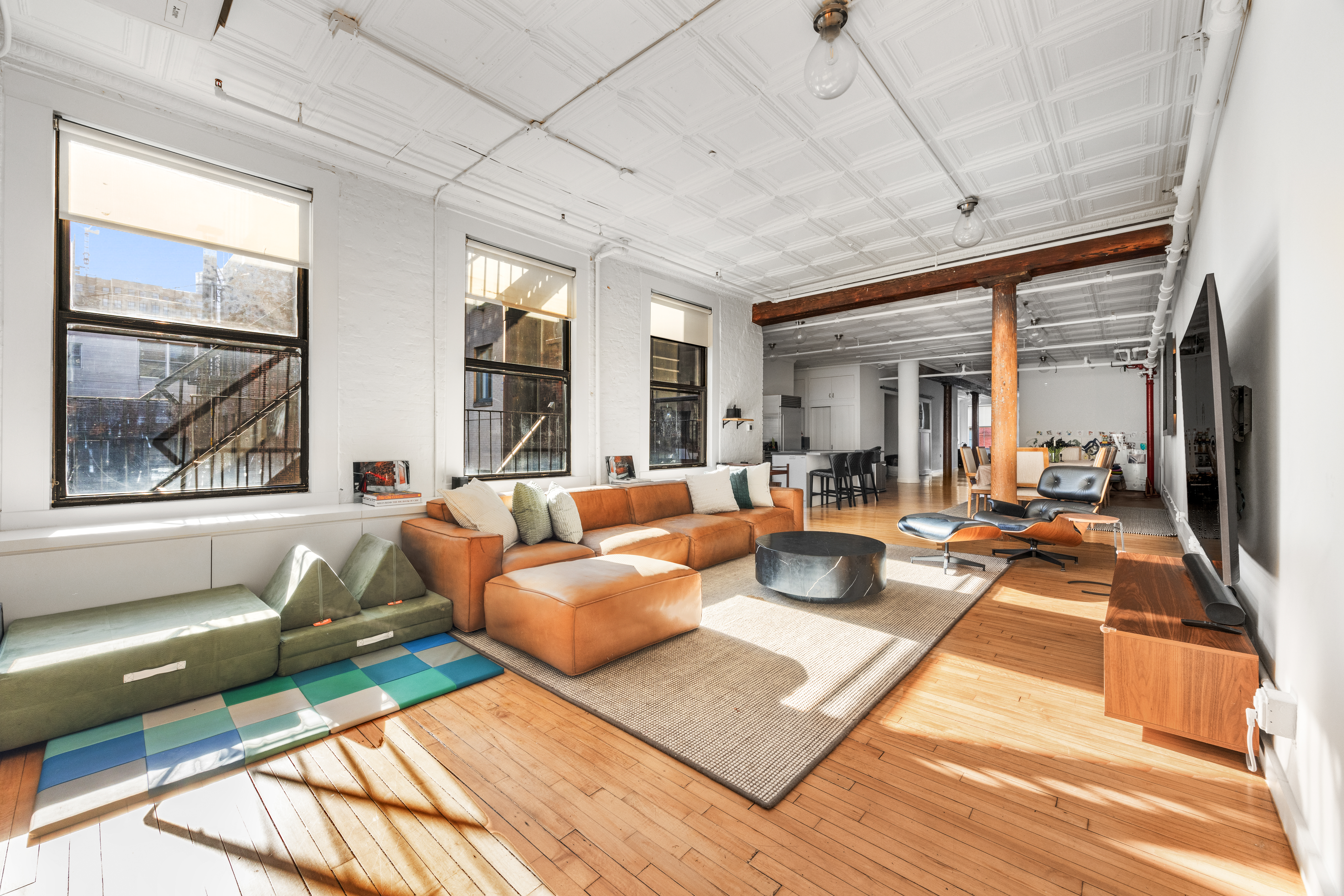 5 White Street, Unit 5B Manhattan, NY 10013 - Photo 2 of 21 a living room with furniture and a large window
